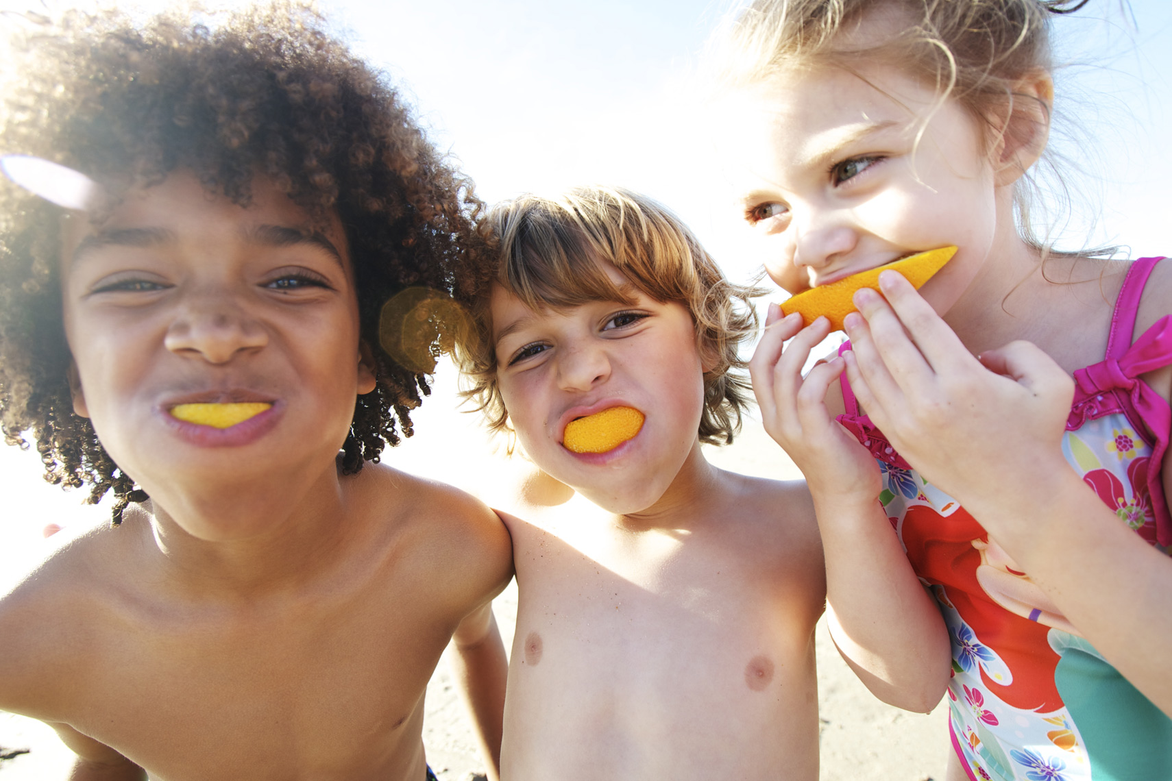 Kids enjoying orange slices as smiles/ Steve Mason Photography