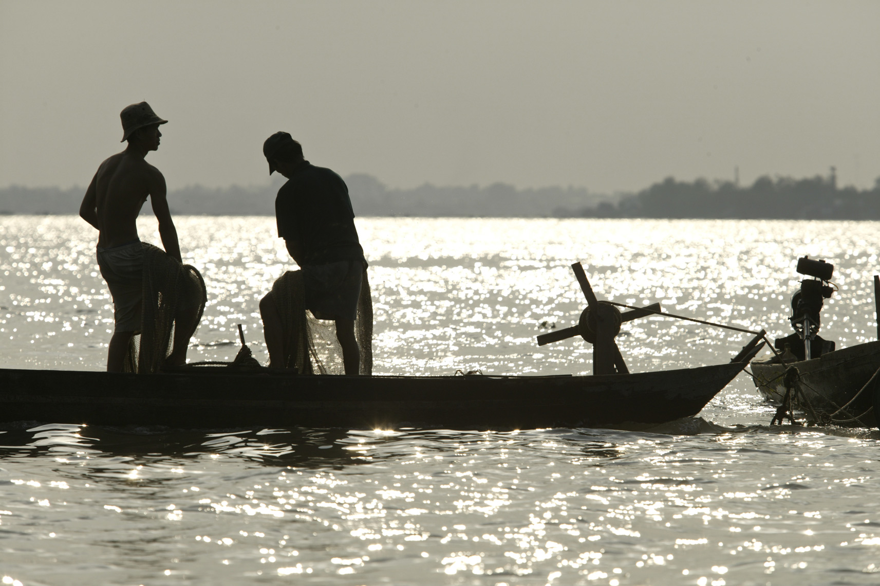 Fisherman strain on nets Meknong Delta/Steve Mason Photography