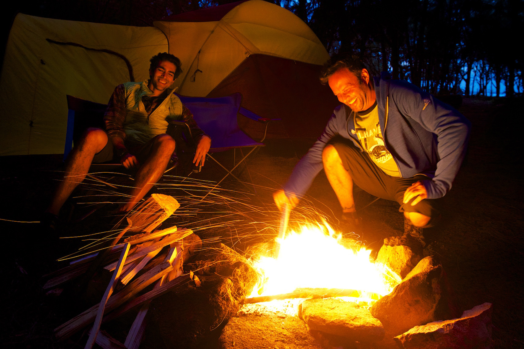 Friends around a big campfire in Hawaii